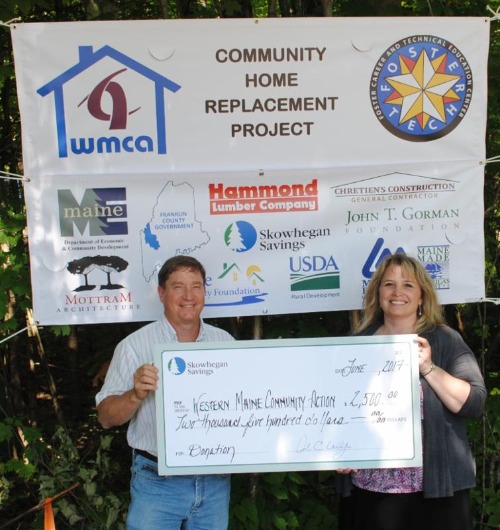 Skwohegan team presenting a check to WMCA Home Replacement Program